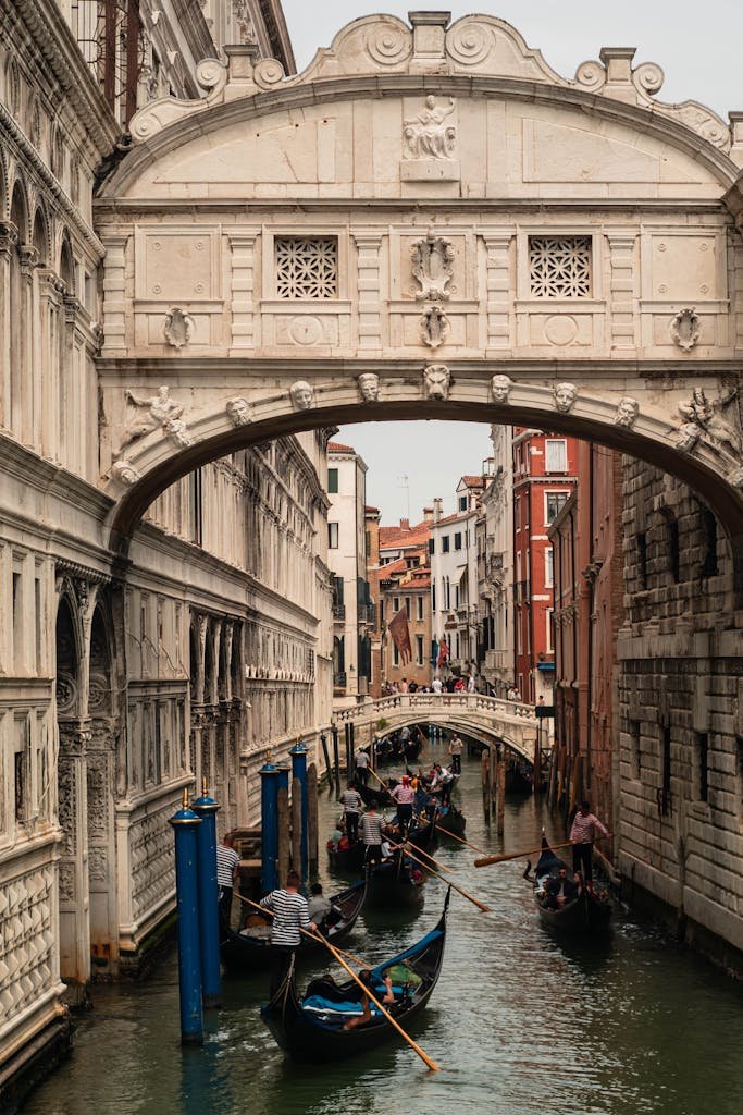 Capture of Venice's Bridge of Sighs with gondolas in the canal below, a classic travel scene.