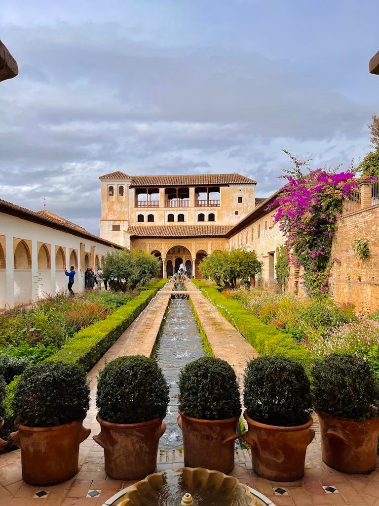 Explore the beautiful gardens of the Generalife Palace, a stunning landmark in Granada, Spain.
