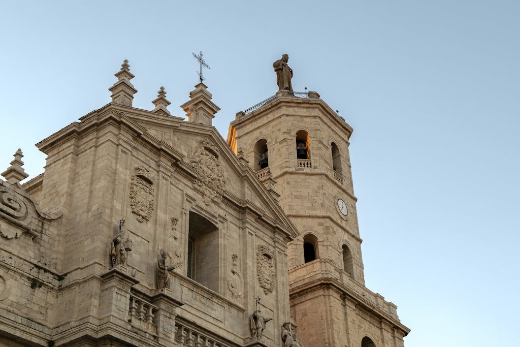 Low-angle view of an ornate cathedral in Valladolid, Spain, showcasing stunning baroque architecture.