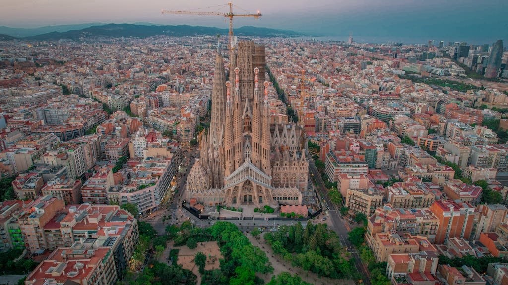 Stunning aerial view of La Sagrada Familia in Barcelona, capturing its architectural beauty and the surrounding cityscape.