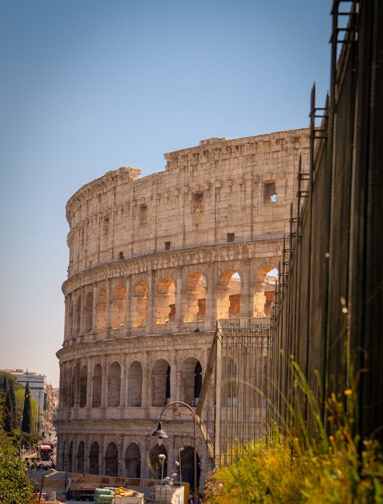 The iconic Colosseum in Rome, Italy on a sunny day with clear blue skies.