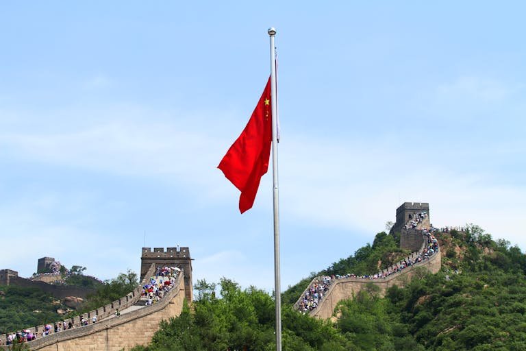 A scenic view of the Great Wall of China with the Chinese national flag in Beijing.