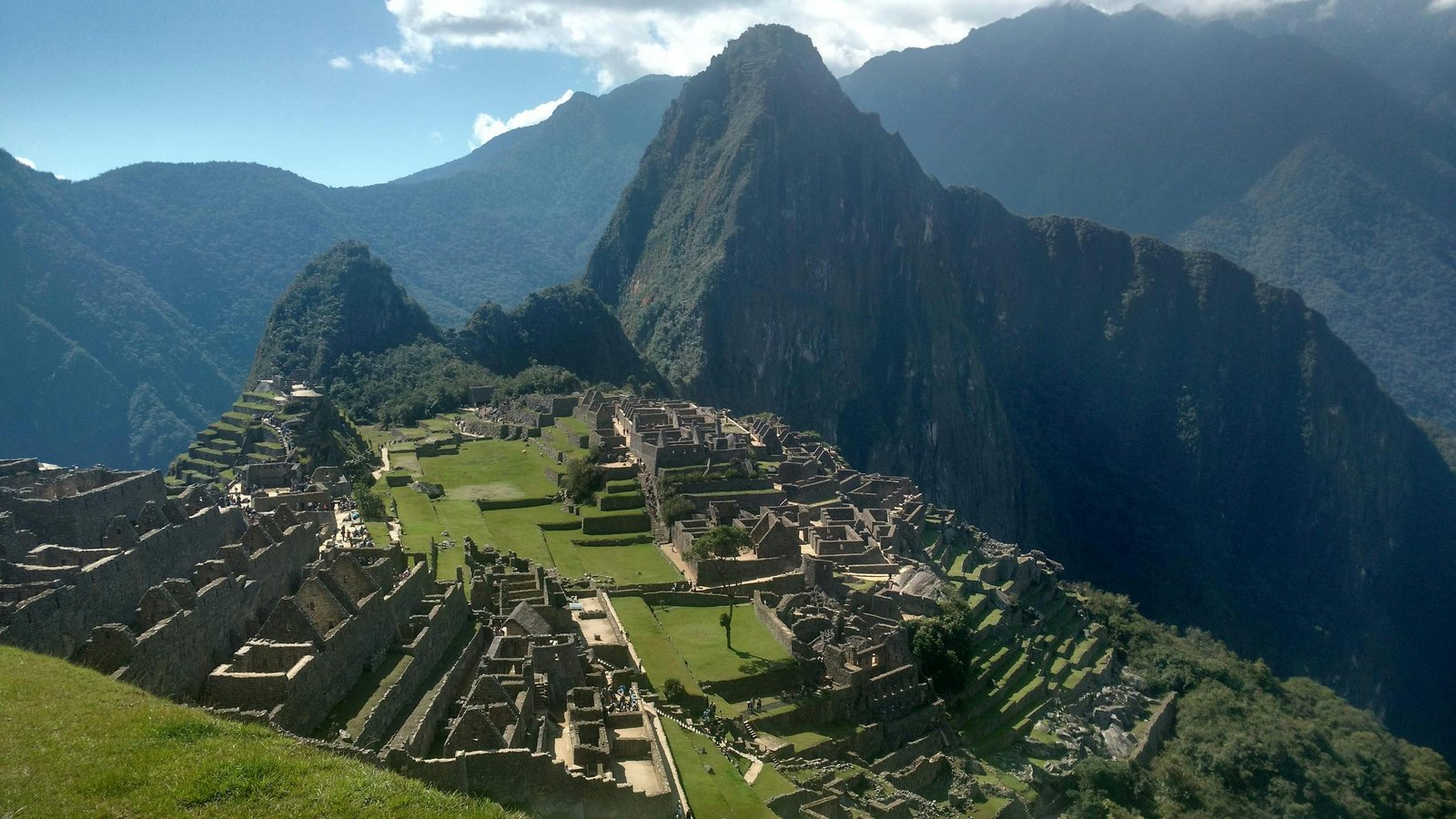 A stunning view of Machu Picchu, the ancient Incan citadel in the Andes mountains of Peru, under a clear sky.